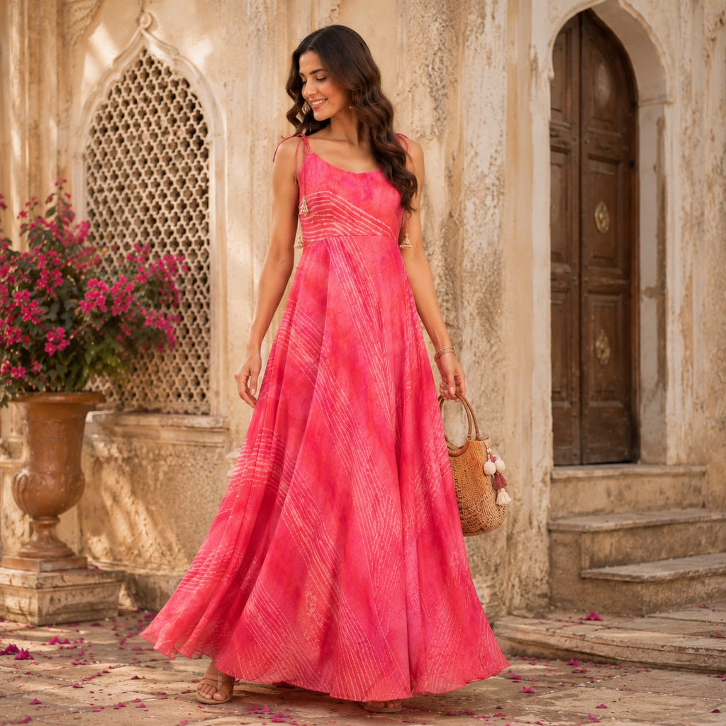 Model wearing Gulabi Maxi pink tie-dye dress in a Rajasthani courtyard